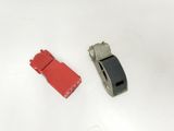two pieces of red and black plastic next to each other