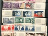 an old photo of a collection of stamps on a table