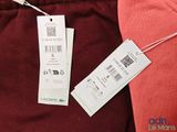 the back of a red shirt with a price tag attached to it