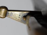 close up of a knife with a metal handle on a white surface