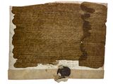 un vieux bout de papier sur lequel figurent des inscriptions et un timbre