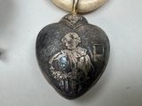 a heart shaped locke with a picture of a man on it