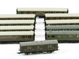 four trains sitting next to each other on a white surface