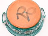 a bowl with a lid that has a bow on it