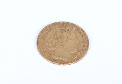 a close up of a gold coin on a white surface