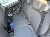 a seat in the back of a car with a bottle in it