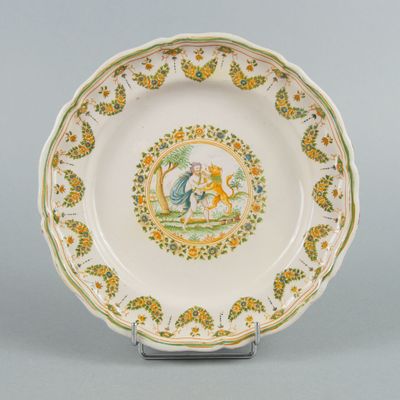 a plate with a picture of a man and a dog on it