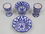 several pieces of blue and white pottery are arranged on a table