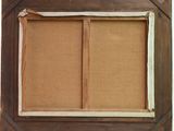 an old picture frame with a picture of a couple of people in it