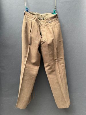 a pair of pants hanging on a hanger on a wall