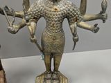 three bronze figurines of a woman and a man holding hands