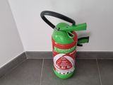 a green fire extinguisor sitting on the floor