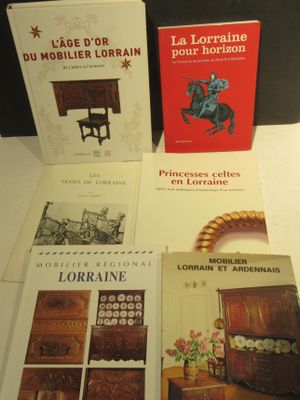 four books are sitting on a table next to each other