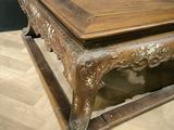 a wooden table with a wooden top on a wooden floor