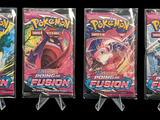 three packs of pokemon trading cards on a black background