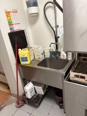 a small kitchen with a sink and a dishwasher