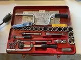 a red tool case with tools in it on a table