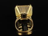 a close up of a gold ring with a black stone in it