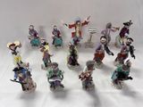 many figurines of different sizes and colors on a white surface