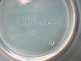 a close up of a blue vase with a white lid