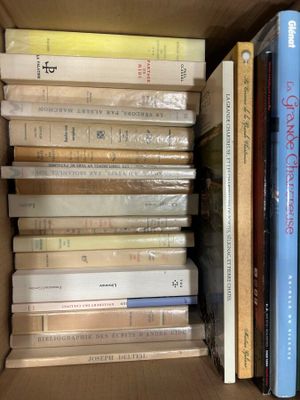 many books that are stacked in a box together
