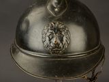 a silver helmet with a lion head on top of it