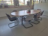 a table with chairs around it in a room