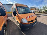 two orange vans parked in a parking lot next to each other