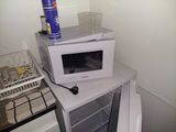 a microwave oven sitting on top of a small table