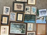 a lot of framed pictures on the floor of this room