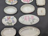 six pieces of porcelain dishes with floral designs on them on a table