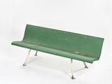 a green bench that is sitting on a white surface