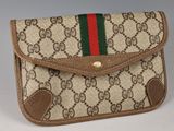 beige guccissi wallet with red, green, and red stripe