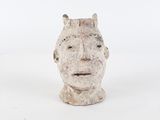 sculpture of a man ' s head on a white surface with a white background