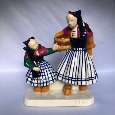 a figurine of a man and a woman holding hands