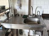 a kitchen with a sink and shelves in it