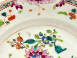 a plate with a floral design on it on a table