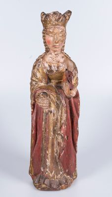 an old statue of a woman in a red dress sitting on a chair
