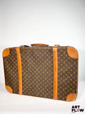 LOUIS VUITTON Grande valise à double sangle en toile enduite…