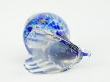 a glass object that is sitting on a white surface