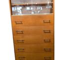 a tall wooden cabinet with a glass top