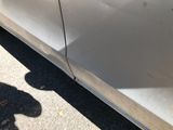 a shadow of a person standing next to a car