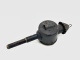 a small black object that is sitting on a white surface