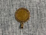 a gold coin sitting on top of a piece of cloth