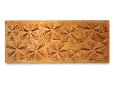 a close up of a wooden plaque with a design on it