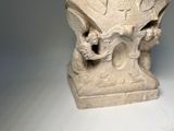 a statue of a woman that is sitting on a table
