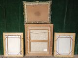 three picture frames sitting next to each other on the floor