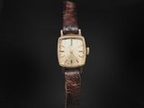 a close up of a watch on a black background