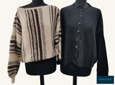 two sweaters on a mannequin stand on a white background