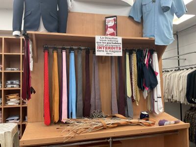 a display of ties and shirts on a shelf in a store